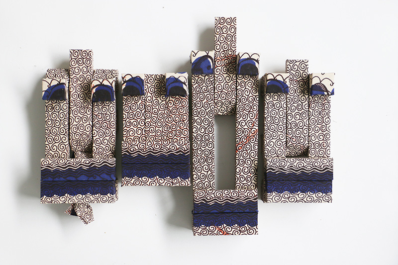 Bassa, 2016 | Dutch-Wax printed fabric on wood, 17" x 27" x 3"